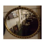 20th century oval wall hanging mirror with bevelled glass, rococo style decoration, 18ins x 21ins