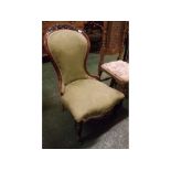 Victorian mahogany framed balloon back nursing chair with carved floral top, green floral