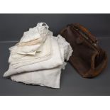 Small collection of vintage lace and other table linen, together with a small leather Gladstone bag