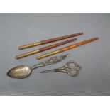 Packet containing three wooden handled/brass glass cutters, an American "Sterling" spoon stamped "