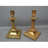 Pair of Victorian cast brass candlesticks, with foliate embossed square bases, 7 ins tall