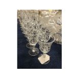 Suite of 20th century English drinking glasses, the bowls of facetted inverted bell form, four 6 ins