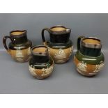 Graduated matched set of four Royal Doulton stoneware harvest pattern jugs, green and khaki glaze