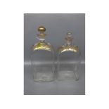 Pair of similar early 19th century clear glass spirit flasks with painted grape vine decoration in