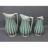 Set of three Victorian graduated stoneware jugs, decorated with green and white geometric designs to