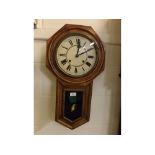 Reconditioned oak cased drop case wall clock with Roman numerals to a cream dial, striking movement,