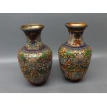 Pair of 20th century oriental metal vases, champlev decorated with abstract designs, 6 ins tall (2)