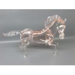 20th century glass model of a cantering horse with a puce glass body and clear glass legs, tail