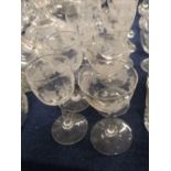 Group of twelve Edwardian wheel-engraved wine glasses, with grape vine decoration, one similar and