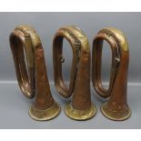 Collection of three vintage copper and brass bugles, lacking mouth-pieces, 10" long