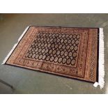 @Modern Bokhara rug with blue ground, repeating central lozenges, multi-gulled border, 190" x 140"