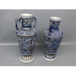 Pair of blue ground stoneware two-handled vases, with raised foliage relief, 9 1/2 ins tall