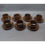 Set of seven 1970s brown glazed cups and saucers in Wedgwood Pennie pattern, (7)