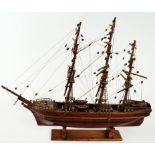 Vintage wooden scale model of a three-masted sailing ship, fully rigged, articulated tiller, painted