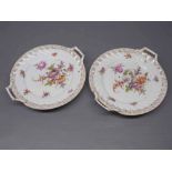 Pair of Dresden circular two-handled plates with floral painted centres and gilt borders,approx