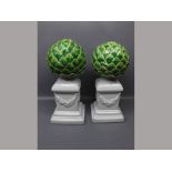 Pair of 20th century ornaments modelled as artichokes,raised on square white glazed stepped stands,