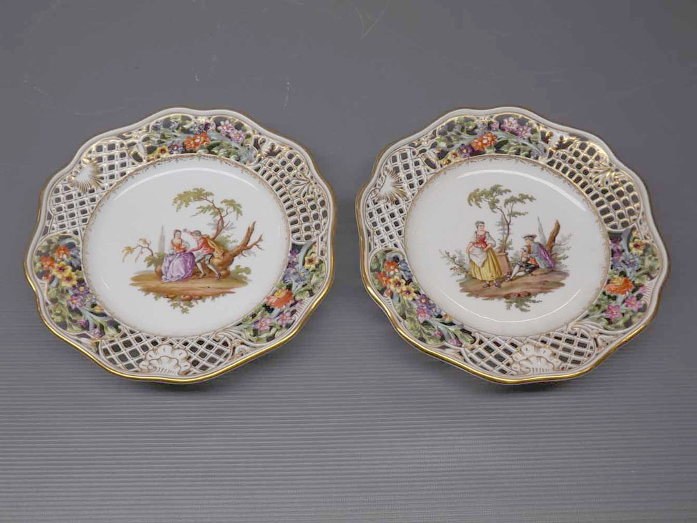 Pair of 19th century Meissen plates with painted figure centres,open work edge,painted floral