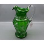 20th century green glass ewer decorated in the Mary Gregory manner,with clear glass shaped handle,