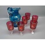 Set of six cut glass cranberry wine glasses with clear stems,together with a Victorian blue