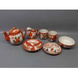 Late 20th century Japanese part tea set with rust ground,floral design,comprising a teapot,one cup