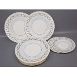 Group of eight Minton bone china plates,white ground with blue and gilt foliate edges,two 6 1/4