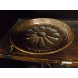 19th century copper pie mould,with impressed daisy centrally with brass hanging loop,11ins diameter