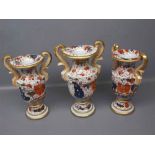 Three Ironstone two-handled vases with grotesque mounted faces,in Imari colours,comprising a pair