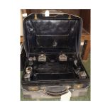 Black leather partially fitted gents vanity case,with silver-lidded jars with gilded impressed