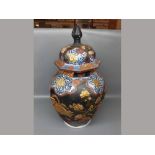 20th century octagonal Oriental lidded vase with raised gilded design of birds among foliage,black