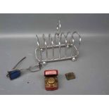 Seven bar silver plated toast rack together with a leather covered travelling inkwell with etched