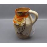 Clarice Cliff small lotus jug decorated in the Rodin design with hairline crack to base,printed