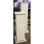TWO MODERN WOODEN PAINTED WHITE DISPLAY COLUMNS 37ins high and 49ins high (2)
