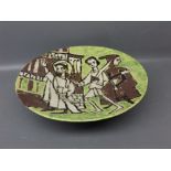 Studio pottery shallow bowl with raised relief and green ground, showing three figures (a/f) 10ins