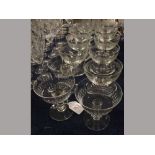 Three clear glass and faceted champagne glasses together with a further set of nine etched clear