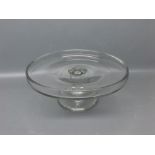 Early 20th century clear glass cake or syllabub stand with raised lip with clear cylindrical column,