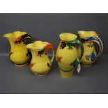 Three Arthur Wood yellow ground jugs with decorative stylised dragon handle, printed mark to base,