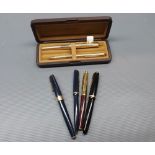 Gold plated fountain pen and matching pen in case, together with three further Parker pens,