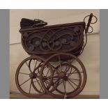 Late 20th century stained dolls pram, in the Victorian manner with metal scrolled handle,