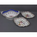 Pair of Continental porcelain lozenge shaped dishes with central floral painted panel, gilded