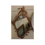 Modern metal framed mirror of lozenge form with twisted metal decoration and foliage detailing, 25 x