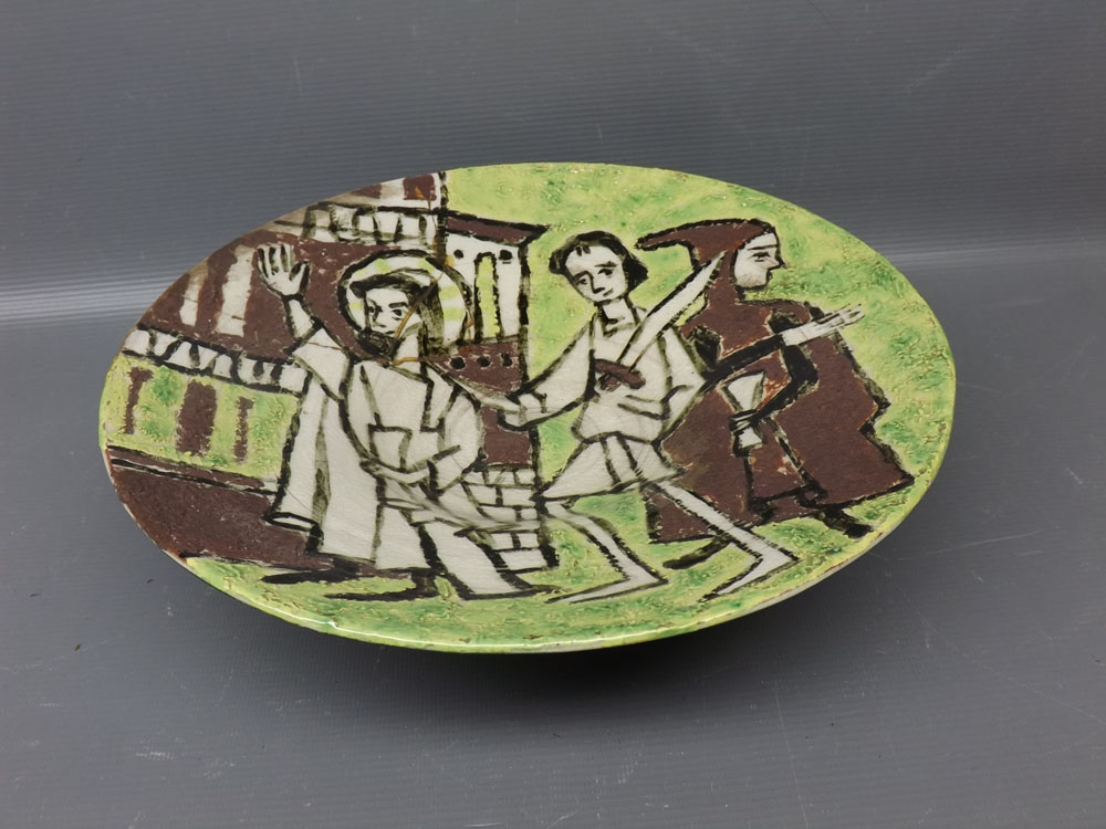 Studio pottery shallow bowl with raised relief and green ground, showing three figures (A/F) 10ins
