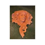 Resin terracotta coloured wall mounted planter, styled as an Art Nouveau lady with flowers in her