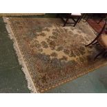 Modern cream ground carpet with central floral detailing, decorated mainly in blue and puce, 68 x