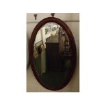 Edwardian mahogany mirror of oval form with inlaid detail, 15 x 26ins