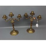 Pair of Arts & Crafts style copper and brass three-light candelabra, 11 1/2 ins tall (2)