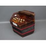 Rosewood effect hexagonal concertina fitted with ten Ivorine buttons, 7ins approx diam