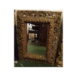 Victorian gilt gesso picture frame with pierced and scrolled edge, holding a mirror, overall size