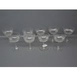 Set of nine clear glass champagne glasses with ribbed decoration, each 5ins tall