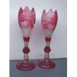Pair of 19th century cranberry Bohemian glass vases, with etched decoration of stag in a wooded