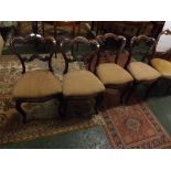 19th century rosewood set of four dining chairs, with shaped bar backs and purple and beige